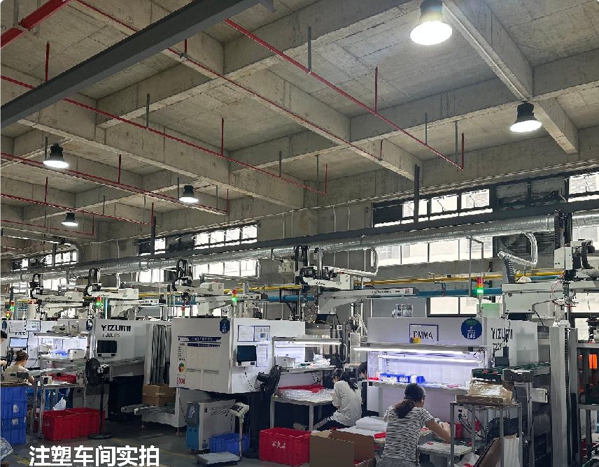 Injection moulding workshop with rows of machines and operators