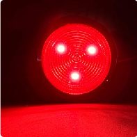 Close up of a red reflex reflector array lit from behind